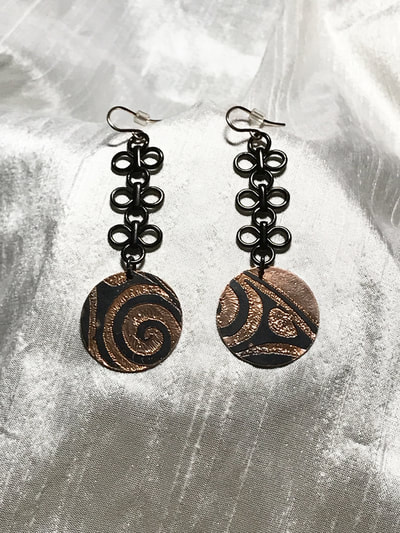C.Tres Prehispanic Panama design hand engraved copper earrings